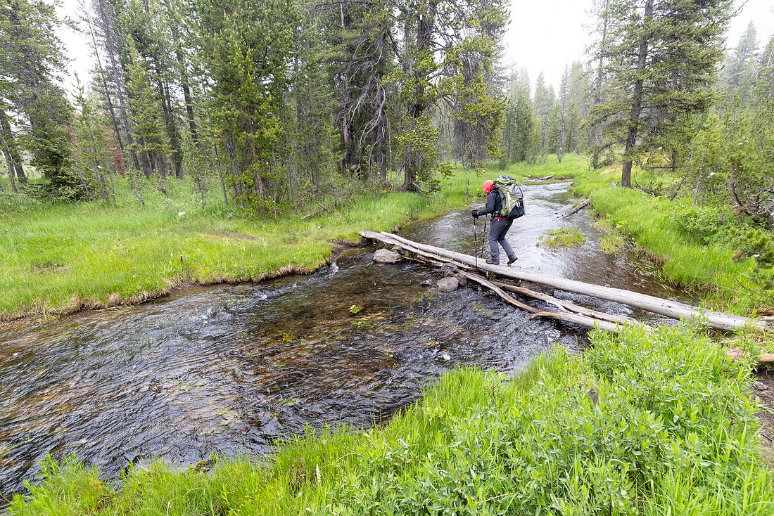 Backpacker crossing Shoshone Creek