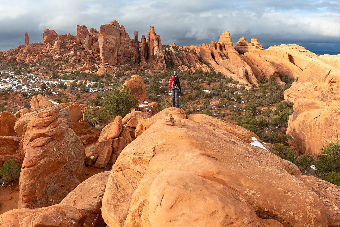 Hiker Near Double O Arch Panorama