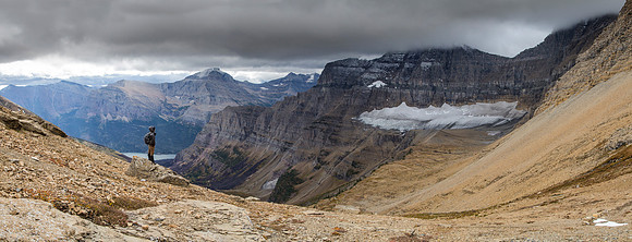 Hiker at Siyeh Pass Viewing Sexton Glacier