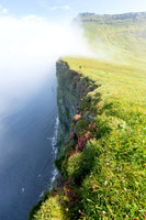 Corrie hiking the Horn as clouds roll over the edge (portrait)