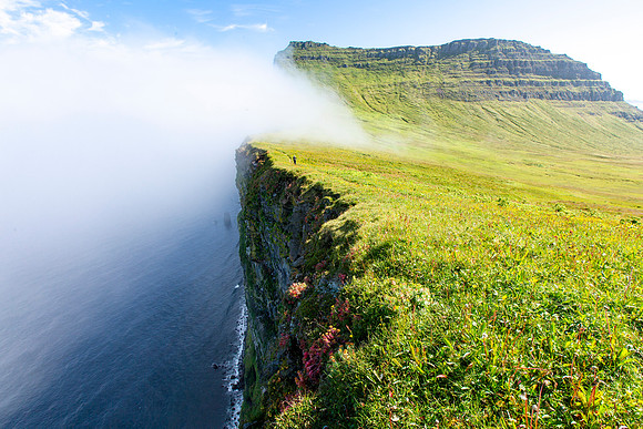 Corrie hiking the Horn as clouds roll over the edge