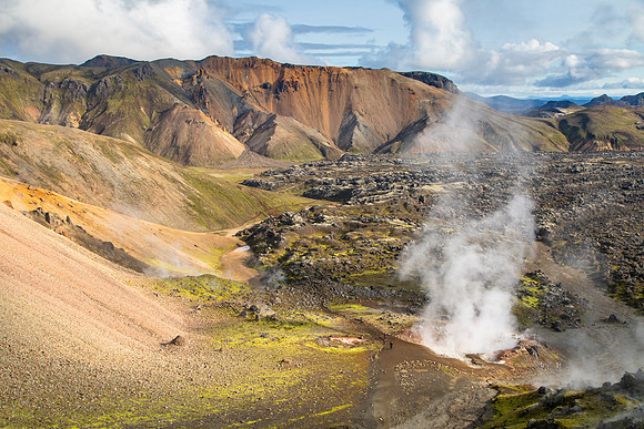 Hikers near a thermal feature on the trail