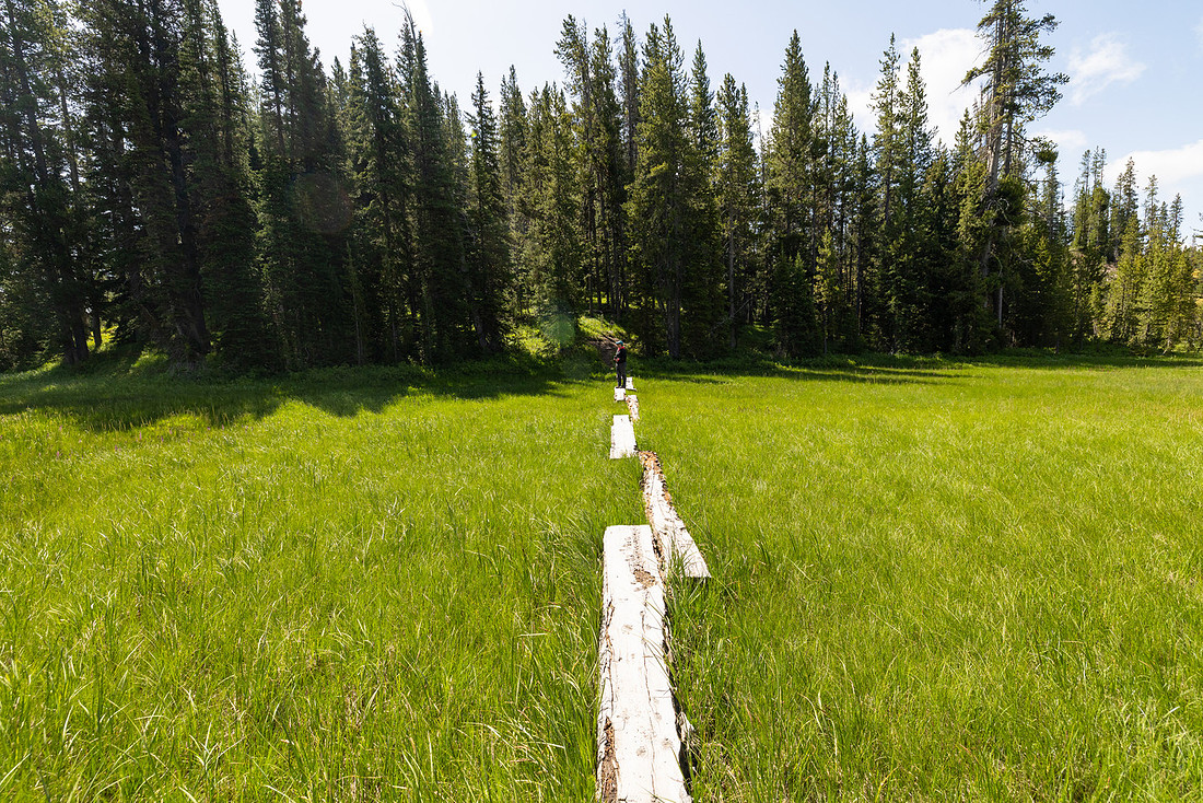 Hiker on foot bridge to enter Shoshone Geyser Basin (2)